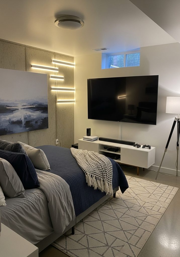 Basement bedroom with TV entertainment setup
